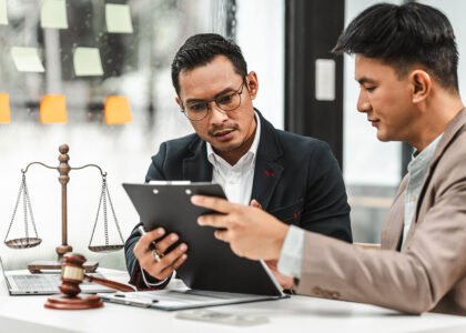 Two professionals reviewing legal documents at desk