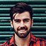 Smiling young man with beard, plaid shirt