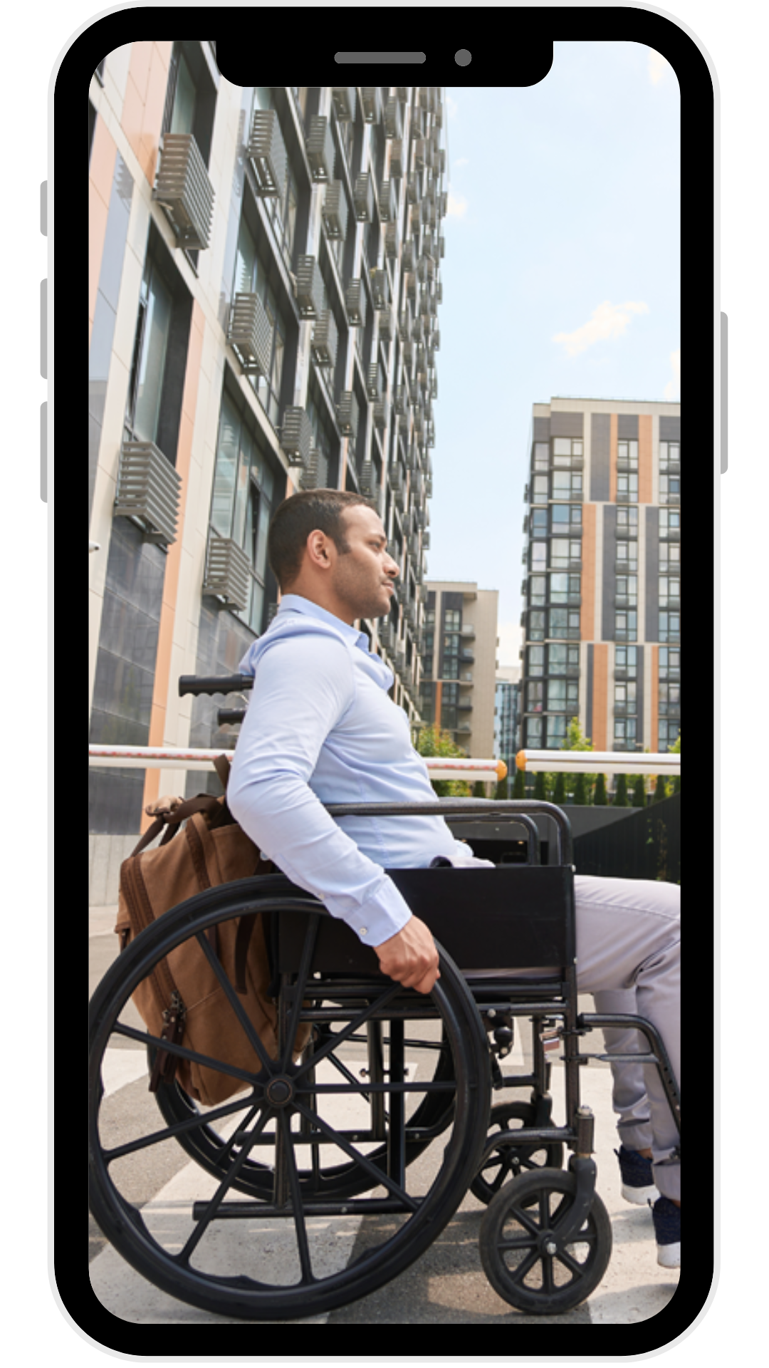Wheelchair user near urban apartment buildings
