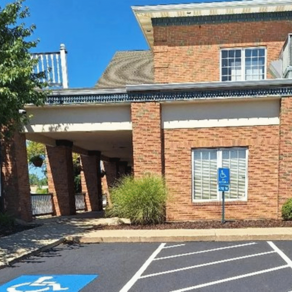 Brick building entrance with accessible parking