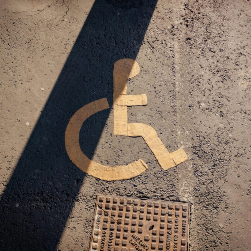 Accessible parking symbol painted on asphalt